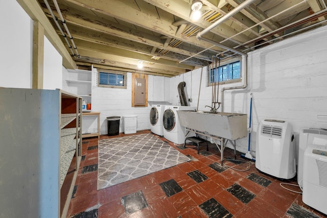 laundry area with sink, washing machine and clothes dryer, and electric panel