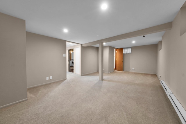 basement with light colored carpet and a baseboard radiator