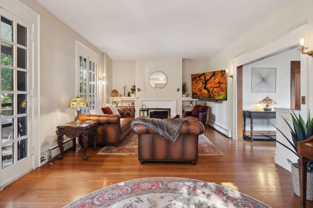 living room with hardwood / wood-style floors and a baseboard heating unit