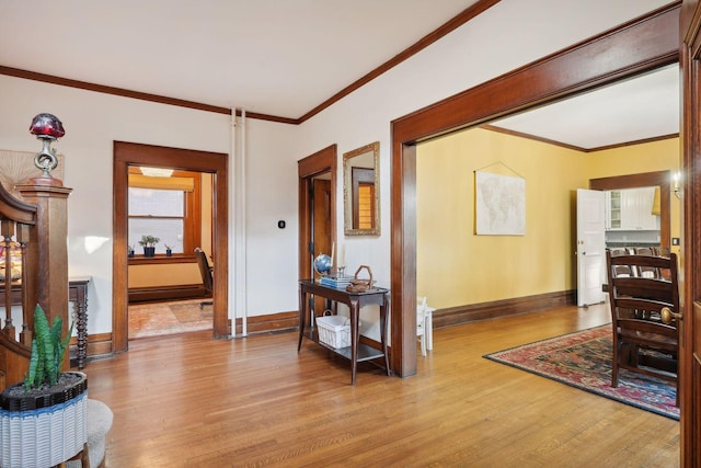 entrance foyer featuring ornamental molding, light hardwood / wood-style floors, and baseboard heating