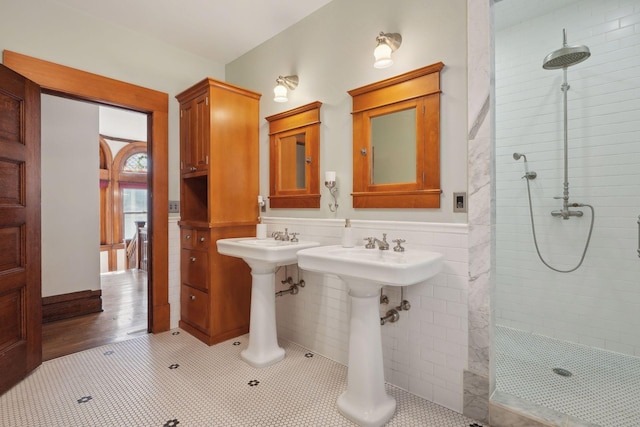 bathroom with tile patterned flooring and a tile shower