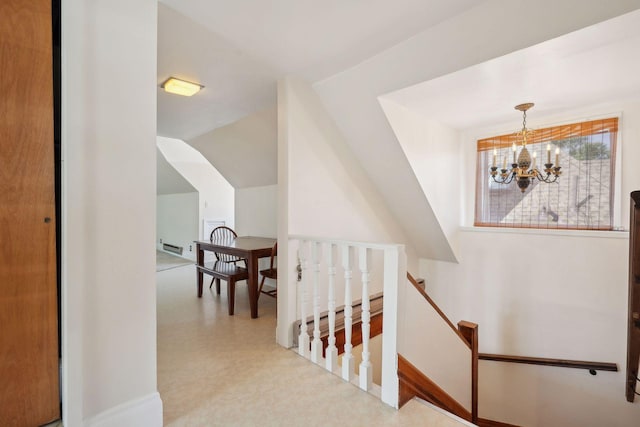 stairway featuring an inviting chandelier and lofted ceiling