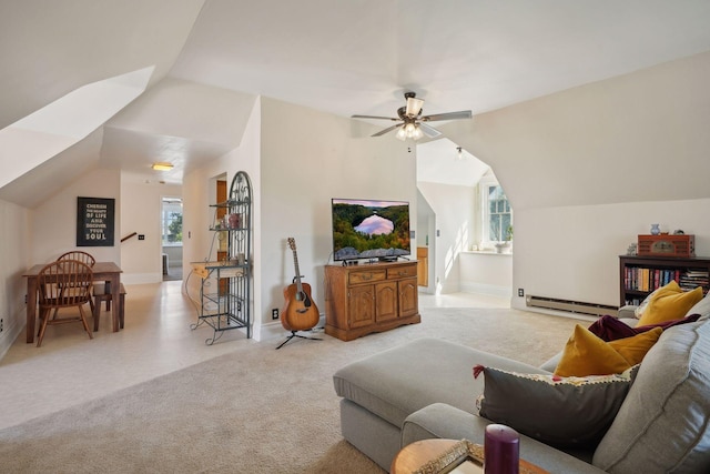 living room with lofted ceiling, a healthy amount of sunlight, light colored carpet, and baseboard heating