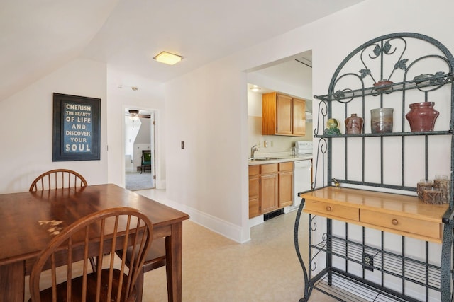 dining room featuring vaulted ceiling, sink, and ceiling fan