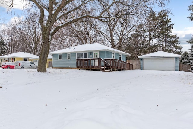 view of front of home with a garage, a wooden deck, and an outdoor structure