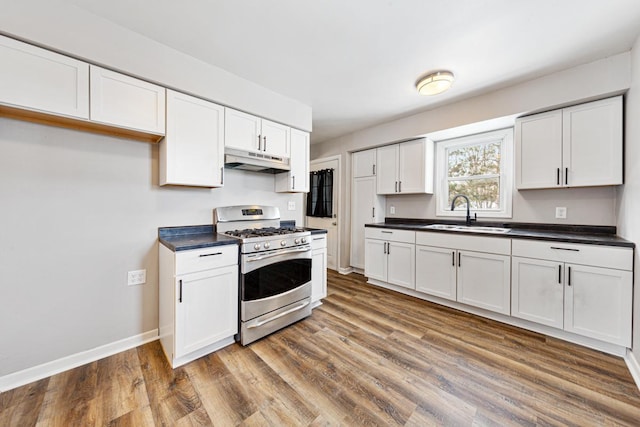 kitchen with hardwood / wood-style flooring, sink, white cabinets, and stainless steel range with gas stovetop