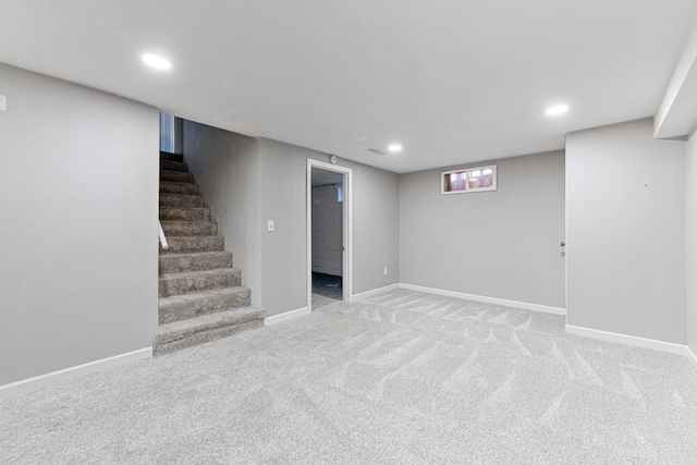 basement featuring light colored carpet