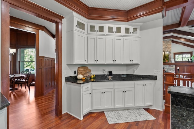 kitchen with dark stone countertops, dark hardwood / wood-style floors, and white cabinets