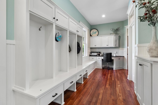 mudroom featuring dark hardwood / wood-style flooring and built in desk