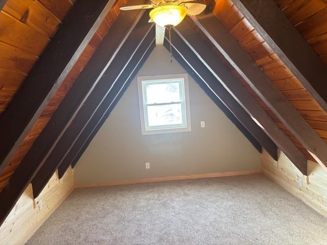 additional living space with ceiling fan, vaulted ceiling, and carpet