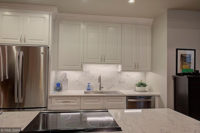 kitchen featuring white cabinetry, sink, tasteful backsplash, and appliances with stainless steel finishes