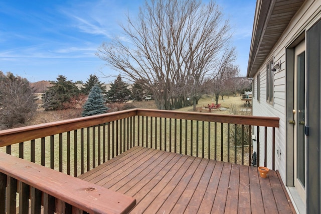 wooden deck featuring a lawn