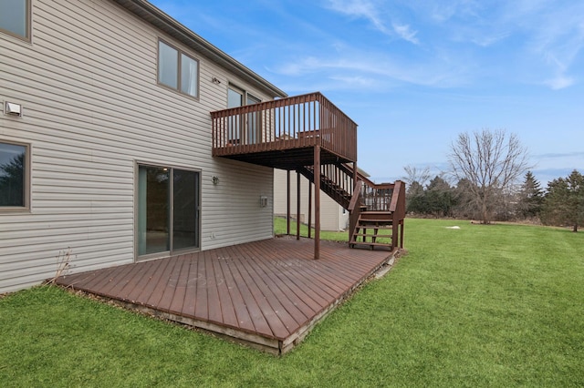 back of property featuring a wooden deck and a lawn