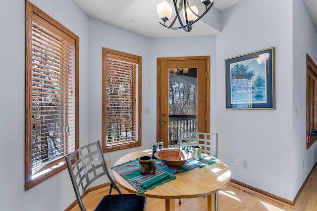 dining room with a chandelier and light hardwood / wood-style floors