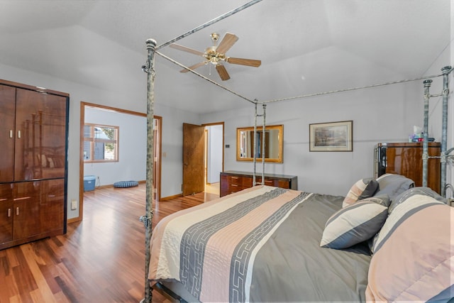 bedroom with vaulted ceiling, hardwood / wood-style floors, ceiling fan, and a closet