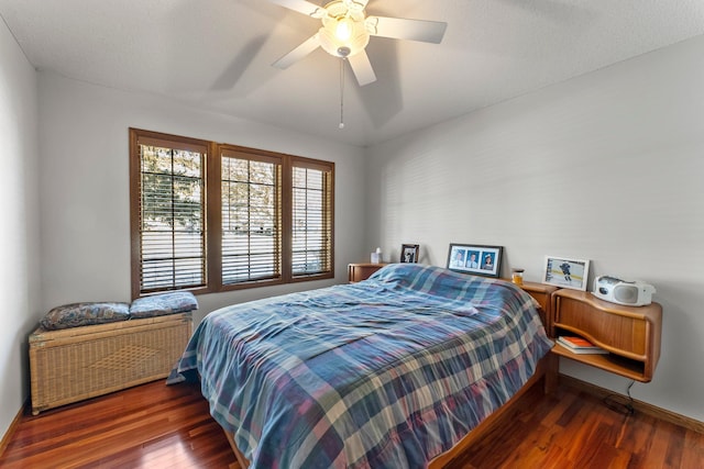 bedroom featuring dark hardwood / wood-style flooring and ceiling fan