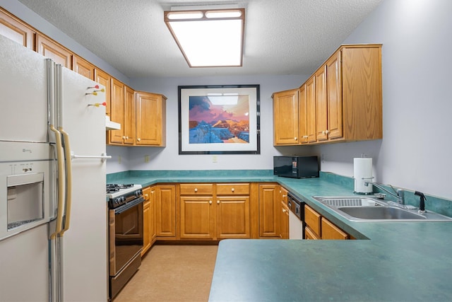 kitchen featuring sink, white appliances, and a textured ceiling