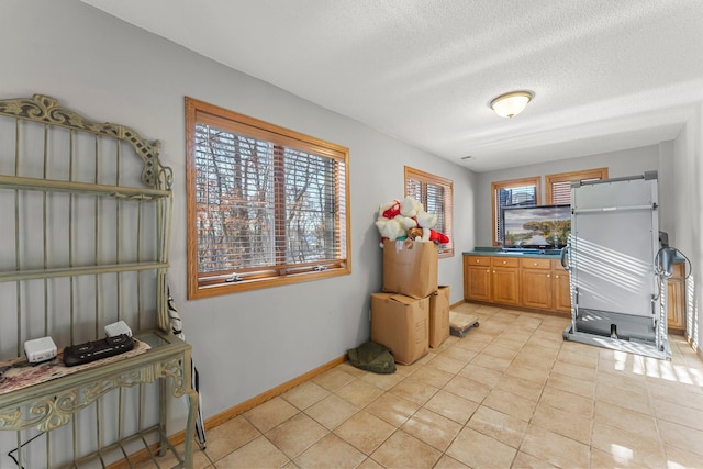 kitchen featuring light tile patterned floors and a textured ceiling