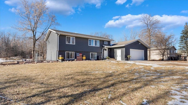 view of front of property featuring a garage and a front lawn