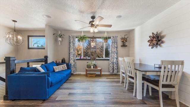 living room with hardwood / wood-style flooring, a textured ceiling, and ceiling fan