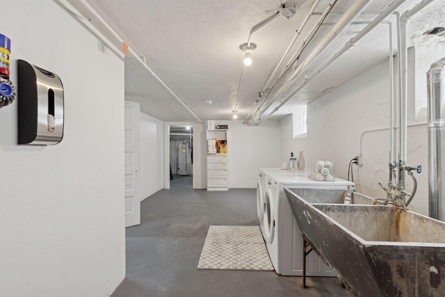 clothes washing area featuring sink and washing machine and dryer