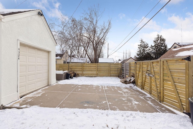 yard layered in snow with a garage