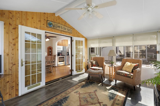 sunroom featuring lofted ceiling with beams and ceiling fan