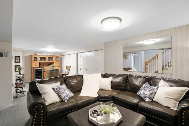 carpeted living area with stairs, wine cooler, and baseboards