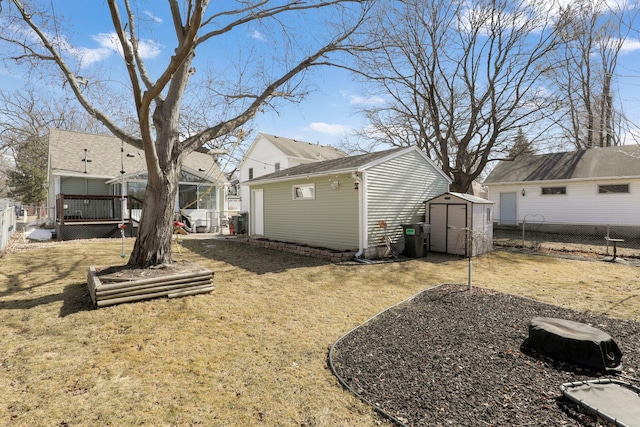 view of yard with an outbuilding, a storage unit, and a fenced backyard