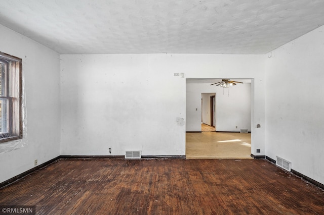 spare room with hardwood / wood-style floors, a textured ceiling, and ceiling fan