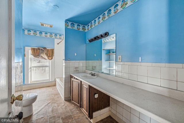 full bathroom featuring shower / washtub combination, toilet, vanity, and tile walls