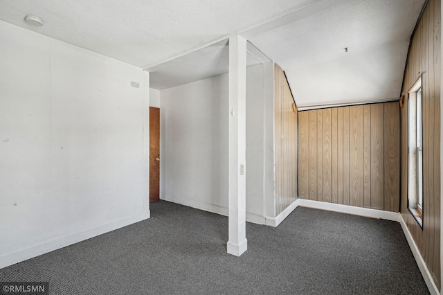 interior space with wooden walls and lofted ceiling