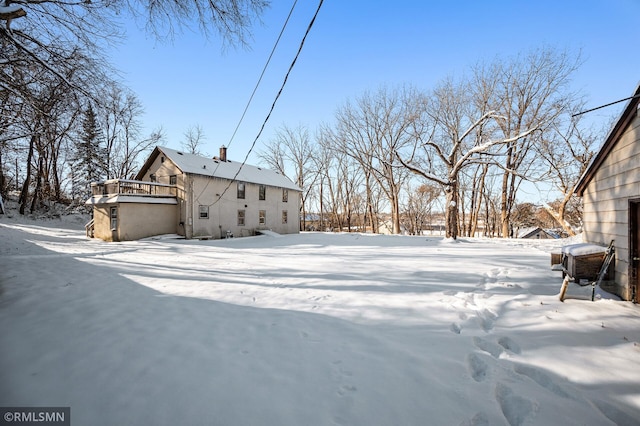 snowy yard with a wooden deck