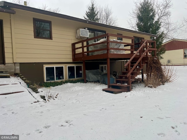 snow covered property with a wooden deck