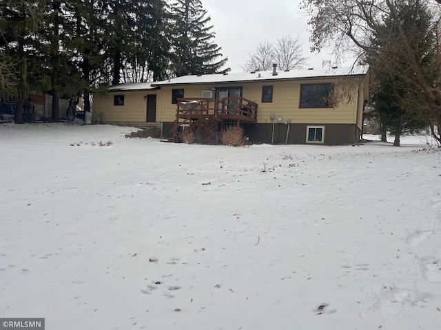 snow covered property featuring a wooden deck