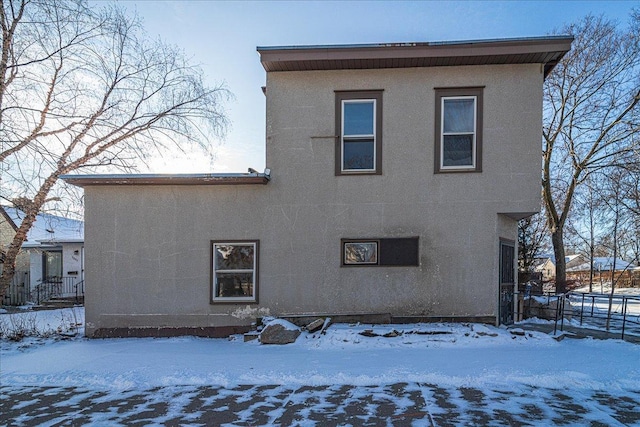 view of snow covered back of property