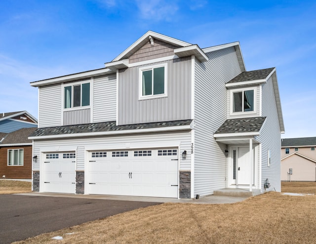 view of front of house with a garage and a front lawn