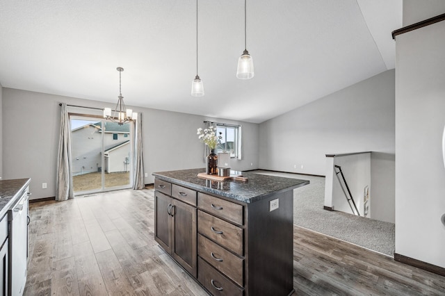 kitchen with a center island, hardwood / wood-style floors, and decorative light fixtures