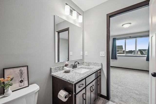 bathroom featuring vanity and toilet