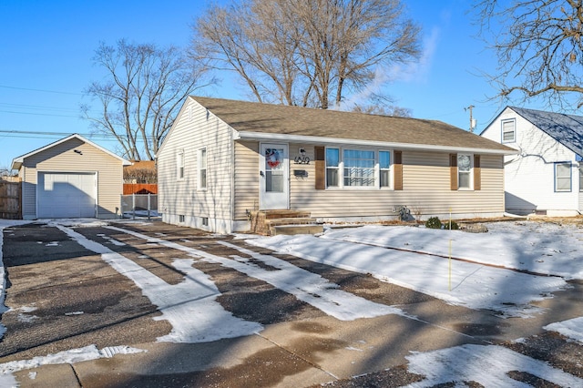 view of front of home with a garage and an outbuilding