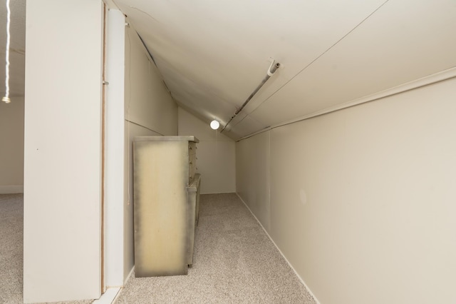 interior space featuring lofted ceiling and light colored carpet