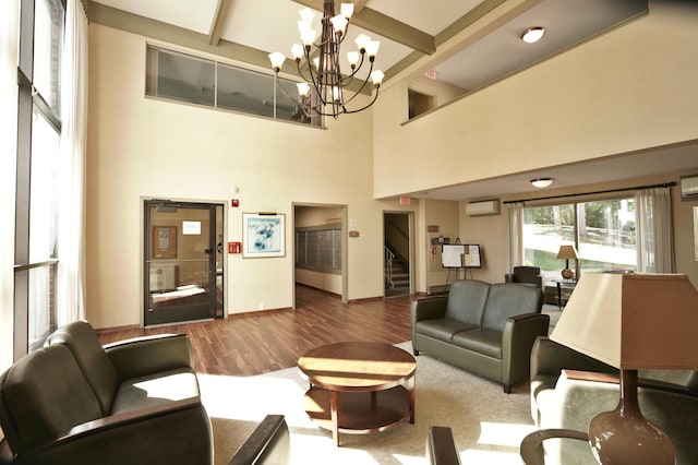 living room with wood-type flooring, a wall mounted AC, and a towering ceiling