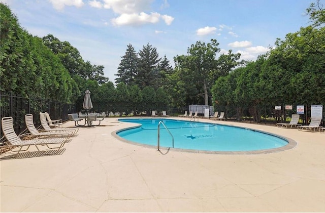 view of swimming pool featuring a patio area