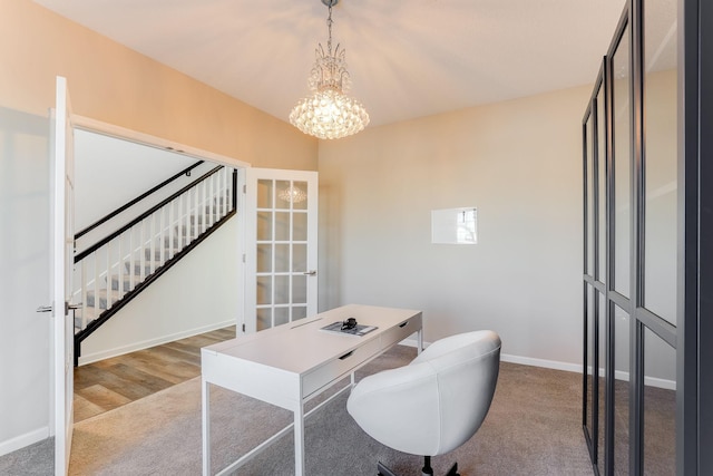 carpeted home office featuring baseboards and an inviting chandelier