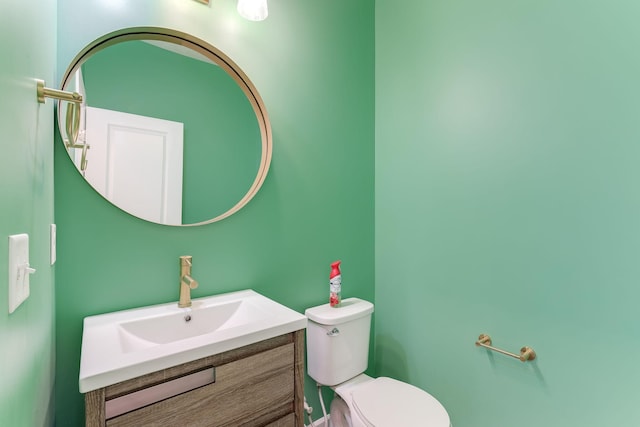 bathroom featuring toilet and vanity