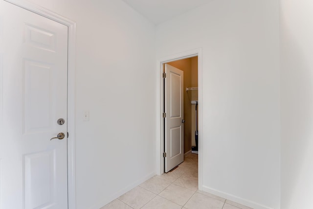 interior space with light tile patterned floors and baseboards