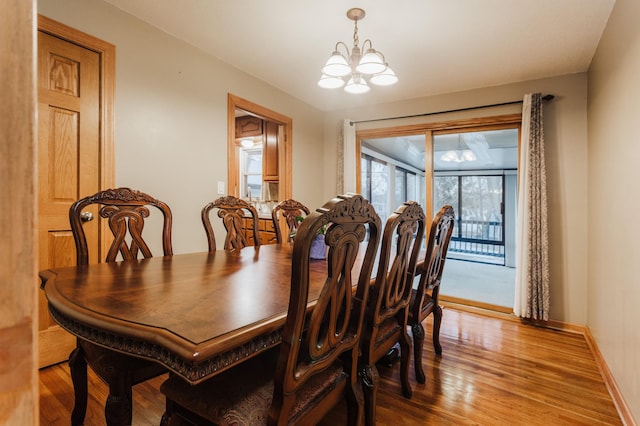 dining room featuring light hardwood / wood-style floors and a notable chandelier