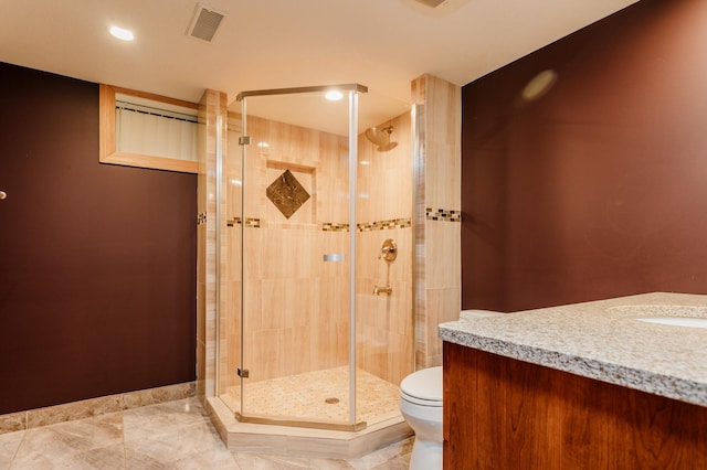 bathroom with a shower with shower door, toilet, and vanity