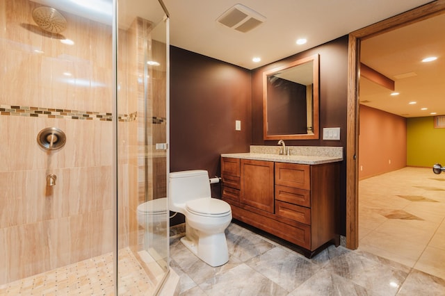 bathroom featuring a tile shower, toilet, and vanity