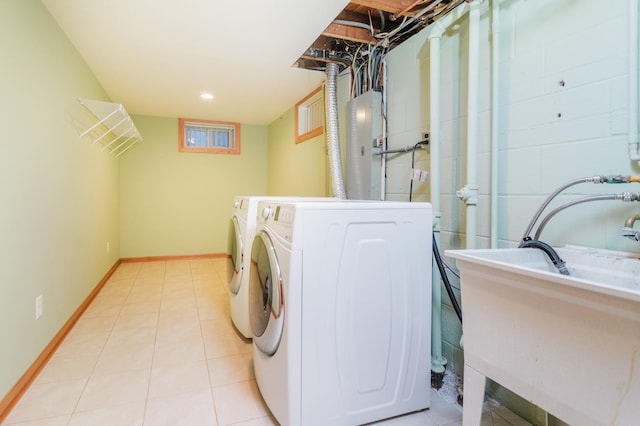 laundry area featuring washer and dryer and light tile patterned floors